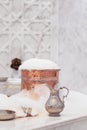 Water jar, towel and copper bowl with soap foam in turkish hamam. Traditional interior details