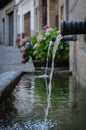 Water jet in a fountain on the streets of a village Royalty Free Stock Photo