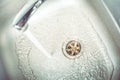 Water Jet Streaming In The Sink And Down The Drain Royalty Free Stock Photo