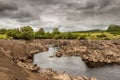 Water of Ken flowing out of a gorge on a drained or dewatered Earlstoun Dam Royalty Free Stock Photo