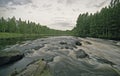 Water landscape with clouds, forest and rift