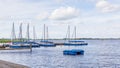 Water landscape with blue sailboats