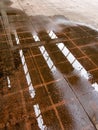 Puddle on tiled floor with skylight reflection.