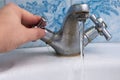 Water leaking from a rusty old faucet in the bathroom Royalty Free Stock Photo