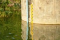 Water level meter on cement wall for flood warning in Wang Bon reservoir Thailand Royalty Free Stock Photo