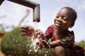 Water is Life for African Children, Little Gorgeous Black Girl Drinking from Tap Royalty Free Stock Photo