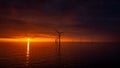 Sunset offshore at wind turbine farm Royalty Free Stock Photo