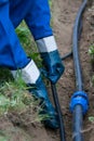 Water master, laying pipes in the trench in the ground to the house