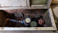 Water meter and pipeline inside a box below floor level