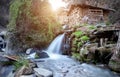 A water mill in a remote mountain area, a mechanical device that uses a waterfall as its power source