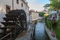 Water mill wheel, canal and restaurant in Prague