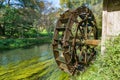 Water mill wheel on river on sunny day Royalty Free Stock Photo