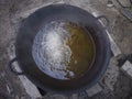 Water mixed with boiling oil, half a large pan.