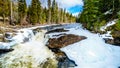 The Murtle River tumbles over the edge of the partly frozen Mushbowl Falls in BC, Canada