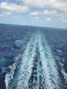 Water of the ocean flowing behind a boat engine