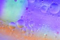Water and oil, beautiful color abstract background based on blue, neon, and orange circles and ovals, macro abstraction