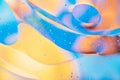 Water oil bubble macro abstract background flow liquid blue aqua yellow pink red colors