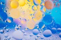 Water oil bubble macro abstract background flow liquid blue aqua yellow pink red colors