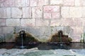 Water outlets in a wall from a spring Royalty Free Stock Photo