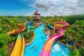 water park with colorful slides and pools, surrounded by greenery