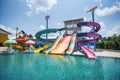 Water park slide with swimming pool at amusement park - colored plastic water slides with pool in outdoor aqua park Royalty Free Stock Photo