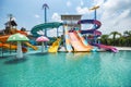 Water park slide with swimming pool at amusement park colored plastic water slides with pool in outdoor aqua park Royalty Free Stock Photo