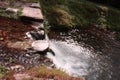 Water path with silk effect. small river flowing from the waterfall in the middle of a wooded plain Royalty Free Stock Photo