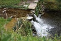 Water path with silk effect. small river flowing from the waterfall in the middle of a wooded plain Royalty Free Stock Photo