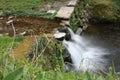 Water path with silk effect. small river flowing from the waterfall in the middle of a wooded plain Royalty Free Stock Photo