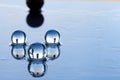 Water pearls abstract with black sphere and reflection on dark surface