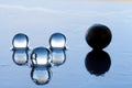 Water pearls abstract with black sphere and reflection on dark surface