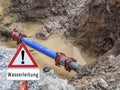 Water pipe burst Warning sign in German Royalty Free Stock Photo
