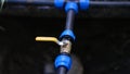 Water pipe faucet connector with closeup for watering plants in garden Royalty Free Stock Photo