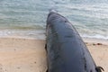 Water pipe going into the Atlantic ocean. Sea water intake pipe at the beach