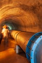 Water pipe or pipeline in a mountain tunnel Royalty Free Stock Photo