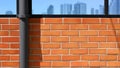 Water pipeline with cityscape reflection on surface of black tinted glass on brick wall background