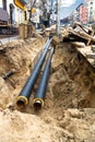 Water pipes in ground pit trench ditch during plumbing under construction repairing Royalty Free Stock Photo