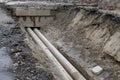 Water pipes in ground during plumbing construction site pit trench ditch Royalty Free Stock Photo