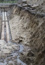 Water pipes in ground during plumbing construction site pit trench ditch Royalty Free Stock Photo