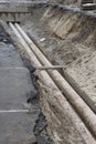 Water pipes in ground during plumbing construction site pit trench ditch Royalty Free Stock Photo