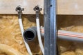 Water pipes made of polypropylene in the wall, plumbing in the house. Installation of sewer pipes in a bathroom of an apartment in Royalty Free Stock Photo