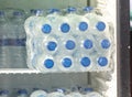 Water in plastic bottles on the shelf in refrigerator. Royalty Free Stock Photo