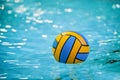 A water polo ball floating on the water in a pool.