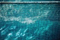 water polo net sitting within the vibrant blue waters of a pool Royalty Free Stock Photo