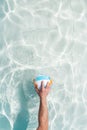 Water polo player with a ball in a blue pool water. Top view. Copy space Royalty Free Stock Photo