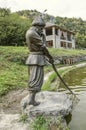 Water pond with sculpture fisherman with abandoned net, on the river Aghstev, near the restaurant `Golden fish` near the town of