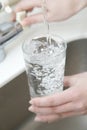 Water poring into a glass Royalty Free Stock Photo