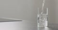 Water pour in highball glass on kitchen countertop