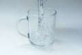 Water is poured into a glass cup Royalty Free Stock Photo
