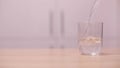 Water poured into a glass slow motion